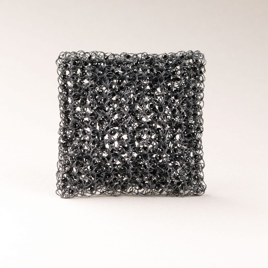 Susan Cross, Shimmer l Brooch, 2025. Oxidised silver, black spinel. 6.5 x 6.5cm.